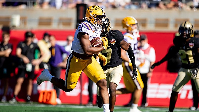 Jan 2, 2023; Orlando, FL, USA; LSU Tigers running back Noah Cain (21) rushes for a touchdown during the first half against the Purdue Boilermakers at Camping World Stadium. Mandatory Credit: Matt Pendleton-USA TODAY Sports