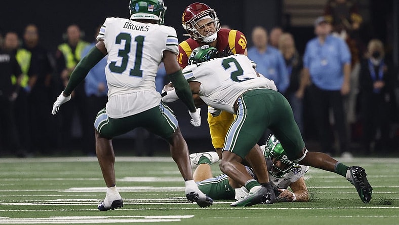 Jan 2, 2023; Arlington, Texas, USA; USC Trojans wide receiver Kyle Ford (81) is tackled by Tulane Green Wave linebacker Dorian Williams (2) in the second quarter in the 2023 Cotton Bowl at AT&T Stadium. Mandatory Credit: Tim Heitman-USA TODAY Sports