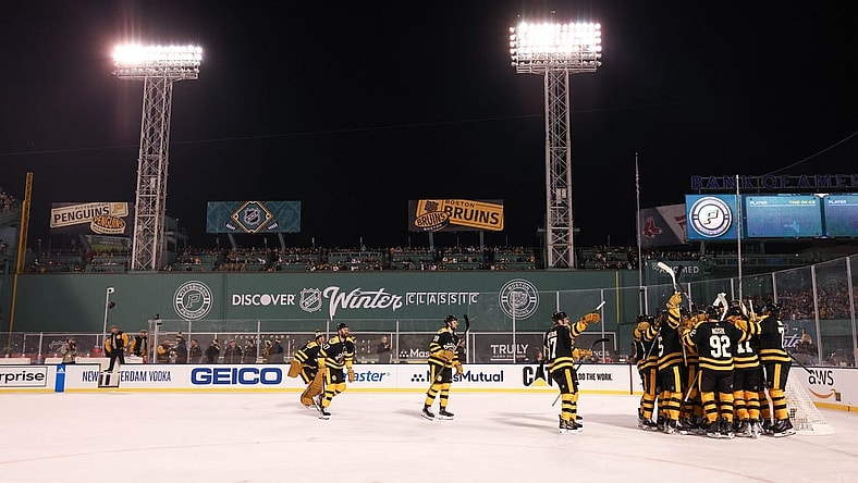 Jan 2, 2023; Boston, Massachusetts, USA; The Boston Bruins celebrate after defeating the Pittsburgh Penguins during the 2023 Winter Classic ice hockey game at Fenway Park. Mandatory Credit: Paul Rutherford-USA TODAY Sports