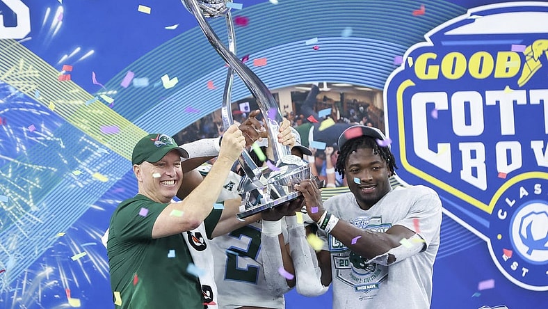 Jan 2, 2023; Arlington, Texas, USA; Tulane Green Wave head coach Willie Fritz lifts the Cotton Bowl trophy with Tulane Green Wave linebacker Dorian Williams (2) and Tulane Green Wave running back Tyjae Spears (22) after the game against the USC Trojans in the 2023 Cotton Bowl at AT&T Stadium. Mandatory Credit: Kevin Jairaj-USA TODAY Sports