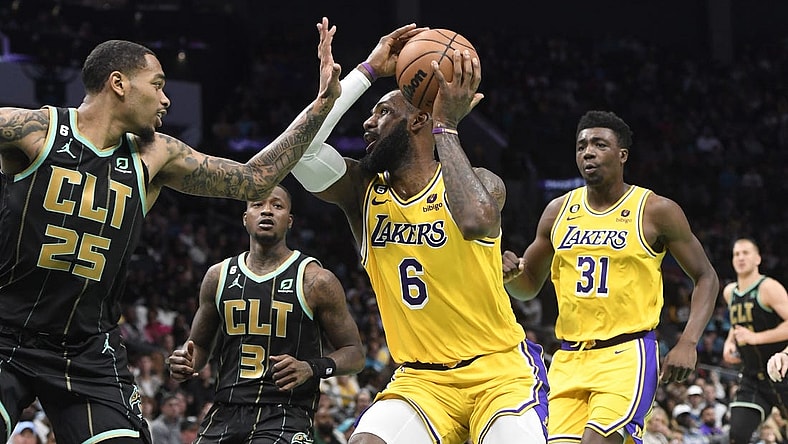 Jan 2, 2023; Charlotte, North Carolina, USA; Los Angeles Lakers forward LeBron James (6) looks to shoot as he is defended by Charlotte Hornets forward P.J. Washington (25) during second half at the Spectrum Center. Mandatory Credit: Sam Sharpe-USA TODAY Sports
