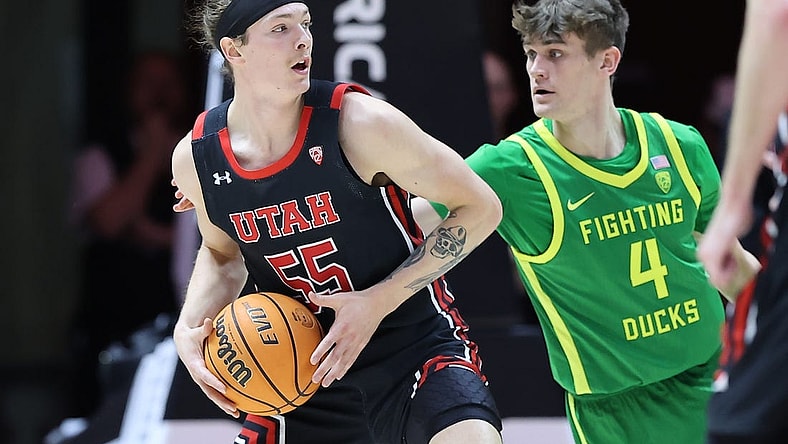 Jan 7, 2023; Salt Lake City, Utah, USA; Utah Utes guard Gabe Madsen (55) looks to pass the ball against Oregon Ducks guard Brennan Rigsby (4) in the first half at Jon M. Huntsman Center. Mandatory Credit: Rob Gray-USA TODAY Sports