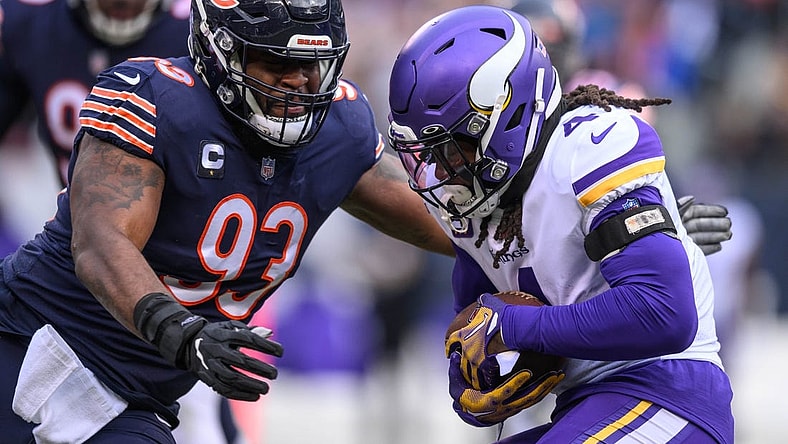 Jan 8, 2023; Chicago, Illinois, USA; Minnesota Vikings running back Dalvin Cook (4) runs the ball and is tackled by Chicago Bears defensive tackle Justin Jones (93) during the first quarter at Soldier Field. Mandatory Credit: Daniel Bartel-USA TODAY Sports