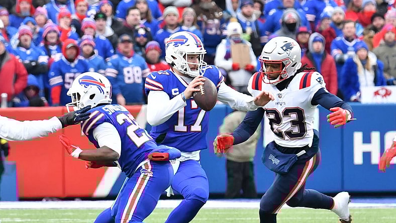 Jan 8, 2023; Orchard Park, New York, USA; Buffalo Bills quarterback Josh Allen (17) is pressured by New England Patriots safety Kyle Dugger (23) in the first quarter at Highmark Stadium. Mandatory Credit: Mark Konezny-USA TODAY Sports