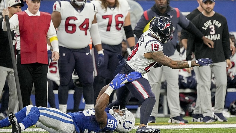 Jan 8, 2023; Indianapolis, Indiana, USA; Houston Texans wide receiver Amari Rodgers (19) slips through the grasp of Indianapolis Colts linebacker Bobby Okereke (58) on Sunday, Jan. 8, 2023, during a game against the Houston Texans at Lucas Oil Stadium. Mandatory Credit: Robert Scheer-USA TODAY Sports