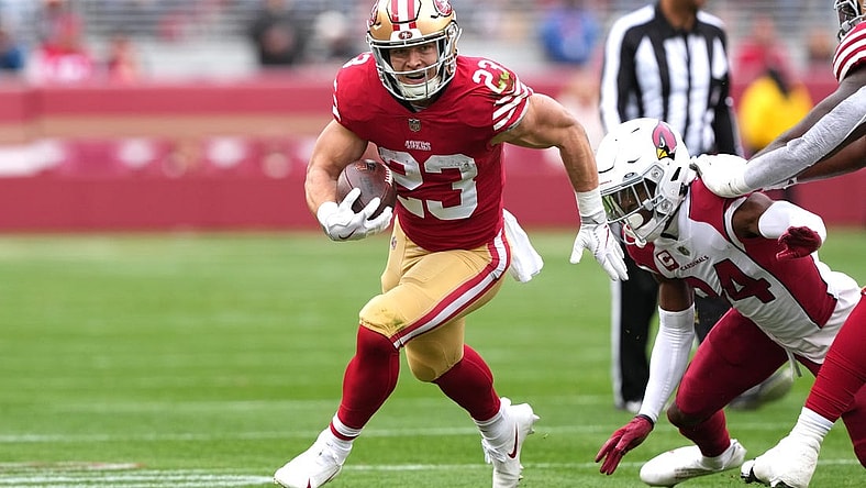 Jan 8, 2023; Santa Clara, California, USA; San Francisco 49ers running back Christian McCaffrey (23) carries the ball against Arizona Cardinals safety Jalen Thompson (34) during the first quarter at Levi's Stadium. Mandatory Credit: Darren Yamashita-USA TODAY Sports