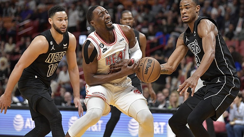 Jan 8, 2023; Miami, Florida, USA;  Miami Heat center Bam Adebayo (13) loses the ball in front of Brooklyn Nets center Nic Claxton (13) during the first quarter of their game at FTX Arena. Mandatory Credit: Michael Laughlin-USA TODAY Sports
