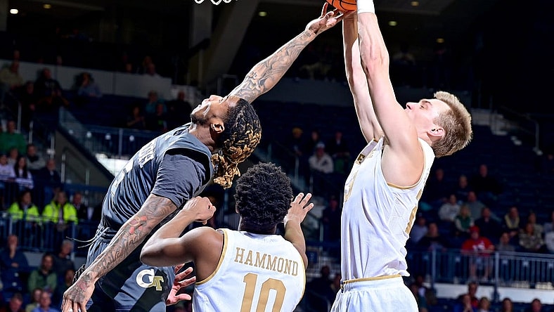 Jan 10, 2023; South Bend, Indiana, USA; Georgia Tech Yellow Jackets guard Deivon Smith (5) and Notre Dame Fighting Irish guard Dane Goodwin (23) reach for a rebound in the first half at the Purcell Pavilion. Mandatory Credit: Matt Cashore-USA TODAY Sports