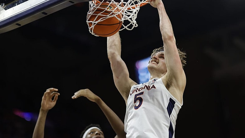 Jan 10, 2023; Charlottesville, Virginia, USA; Virginia Cavaliers forward Ben Vander Plas (5) dunks the ball as North Carolina Tar Heels forward Jalen Washington (13) looks on in the second half at John Paul Jones Arena. Mandatory Credit: Geoff Burke-USA TODAY Sports