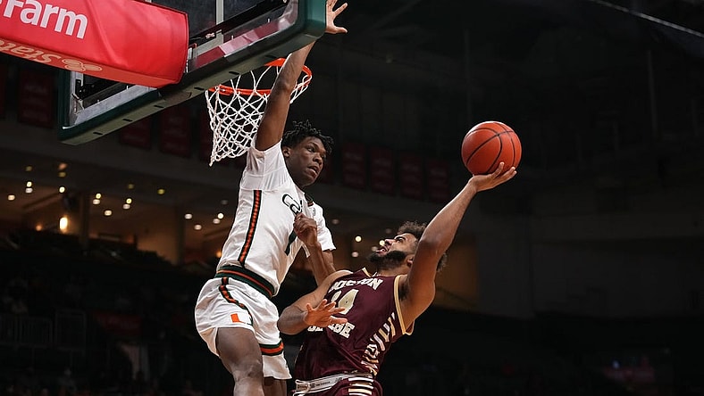 Jan 11, 2023; Coral Gables, Florida, USA; Boston College Eagles forward CJ Penha Jr. (24) shoots the ball against Miami Hurricanes forward Anthony Walker (1) during the first half at Watsco Center. Mandatory Credit: Jasen Vinlove-USA TODAY Sports