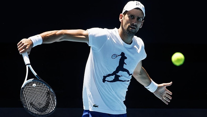 Jan 12, 2023; Melbourne, Victoria, Australia; Novak Djokovic of Serbia hits a backhand during a practice session on Rod Laver Arena with his coach Goran Ivanisevic at Melbourne Park. Mandatory Credit: Mike Frey-USA TODAY Sports