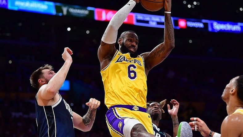 Jan 12, 2023; Los Angeles, California, USA; Los Angeles Lakers forward LeBron James (6) gets the rebound against Dallas Mavericks guard Luka Doncic (77) during the second half at Crypto.com Arena. Mandatory Credit: Gary A. Vasquez-USA TODAY Sports