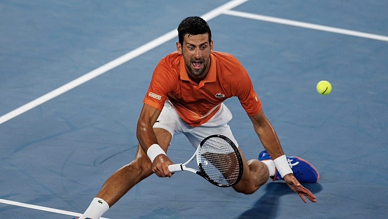 Jan 13, 2023; Melbourne, Victoria, Australia; Novak Djokovic of Serbia hits a shot during an exhibition practice match against Nick Kyrgios of Australia on Rod Laver Arena at Melbourne Park. Mandatory Credit: Mike Frey-USA TODAY Sports