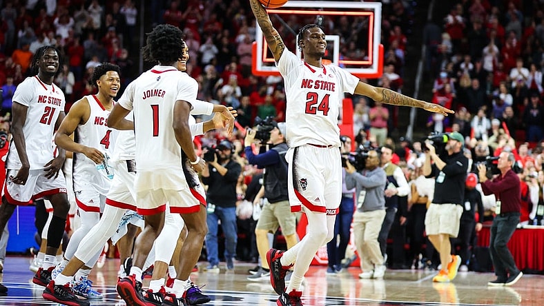 Jan 14, 2023; Raleigh, North Carolina, USA; North Carolina State Wolfpack forward Ernest Ross (24) and teammates celebrate the end of the overtime against Miami Hurricanes at PNC Arena. Mandatory Credit: Jaylynn Nash-USA TODAY Sports
