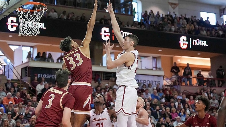 Jan 14, 2023; Charleston, South Carolina, USA; Charleston Cougars forward Ante Brzovic (10) shoots the ball over Elon Phoenix forward John Bowen III (33) in the first half at TD Arena. Mandatory Credit: David Yeazell-USA TODAY Sports