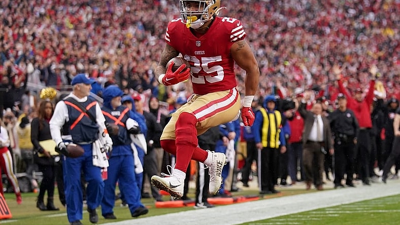 Jan 14, 2023; Santa Clara, California, USA; San Francisco 49ers running back Elijah Mitchell (25) leaps into the end zone for a touchdown in the third quarter of a wild card game against the Seattle Seahawks at Levi's Stadium. Mandatory Credit: Cary Edmondson-USA TODAY Sports