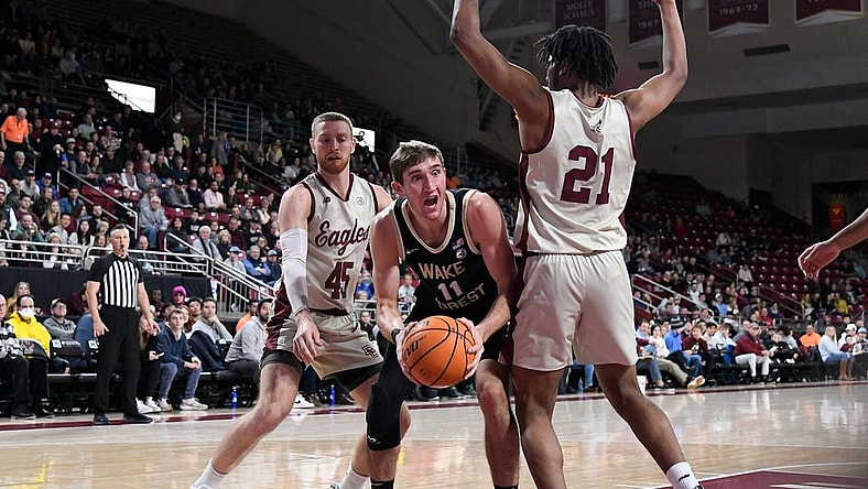 Jan 14, 2023; Chestnut Hill, Massachusetts, USA; Wake Forest Demon Deacons forward Andrew Carr (11) looks for a play around Boston College Eagles forward Devin McGlockton (21)  during the first half at Conte Forum. Mandatory Credit: Eric Canha-USA TODAY Sports