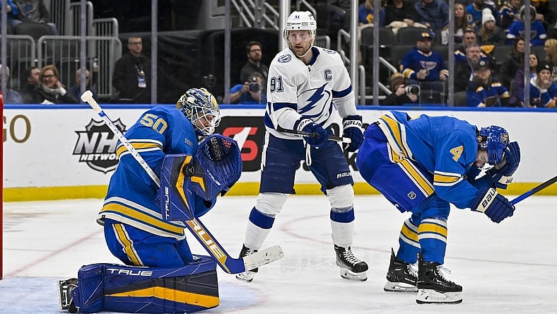 Jan 14, 2023; St. Louis, Missouri, USA;  St. Louis Blues goaltender Jordan Binnington (50) makes a save as defenseman Nick Leddy (4) defends against Tampa Bay Lightning center Steven Stamkos (91) during the third period at Enterprise Center. Mandatory Credit: Jeff Curry-USA TODAY Sports