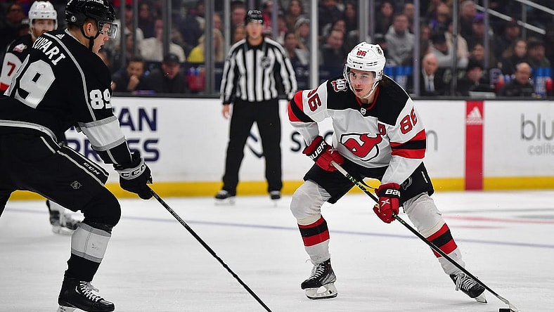 January 14, 2023; Los Angeles, California, USA; New Jersey Devils center Jack Hughes (86) moves the puck against Los Angeles Kings center Rasmus Kupari (89) during the third period at Crypto.com Arena. Mandatory Credit: Gary A. Vasquez-USA TODAY Sports