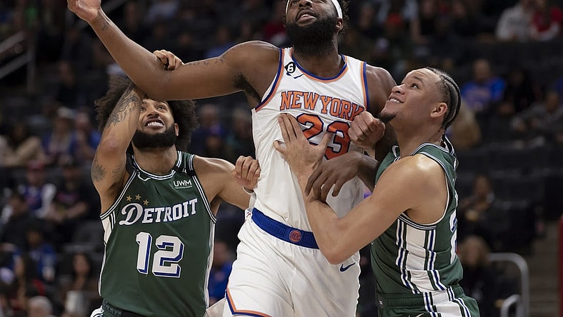 Jan 15, 2023; Detroit, Michigan, USA; New York Knicks center Mitchell Robinson (23) battles for position between Detroit Pistons forward Isaiah Livers (12) forward Kevin Knox II (20) during the first quarter at Little Caesars Arena. Mandatory Credit: David Reginek-USA TODAY Sports