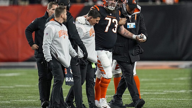 Jan 15, 2023; Cincinnati, Ohio, USA; Cincinnati Bengals offensive tackle Jonah Williams (73) is assisted off the field after being injured on a play in the second quarter during an NFL wild-card playoff football game between the Baltimore Ravens and the Cincinnati Bengals at Paycor Stadium. Mandatory Credit: Sam Greene-USA TODAY Sports