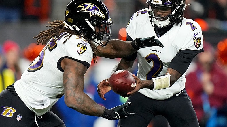 Jan 15, 2023; Cincinnati, Ohio, USA; Baltimore Ravens quarterback Tyler Huntley (2) hands the ball off to Baltimore Ravens running back Gus Edwards (35) in the fourth quarter during an NFL wild-card playoff football game between the Baltimore Ravens and the Cincinnati Bengals during a wild card game at Paycor Stadium. Mandatory Credit: Kareem Elgazzar-USA TODAY Sports