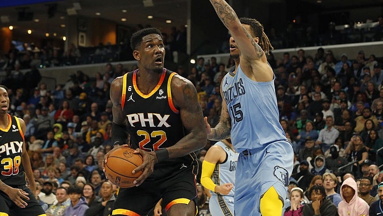 Jan 16, 2023; Memphis, Tennessee, USA; Phoenix Suns center Deandre Ayton (22) spins toward the basket as Memphis Grizzlies forward Brandon Clark (15) defends during the second half at FedExForum. Mandatory Credit: Petre Thomas-USA TODAY Sports