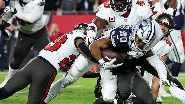 Jan 16, 2023; Tampa, Florida, USA; Dallas Cowboys running back Tony Pollard (20) rushes the ball against Tampa Bay Buccaneers safety Mike Edwards (32) in the first half during the wild card game at Raymond James Stadium. Mandatory Credit: Kim Klement-USA TODAY Sports