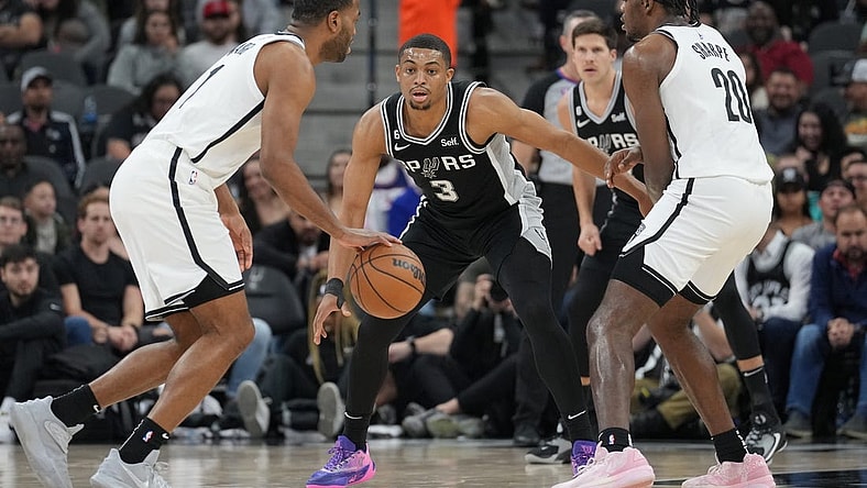 Jan 17, 2023; San Antonio, Texas, USA;  San Antonio Spurs forward Keldon Johnson (3) defends Brooklyn Nets forward T.J. Warren (1) in the first half at the AT&T Center. Mandatory Credit: Daniel Dunn-USA TODAY Sports