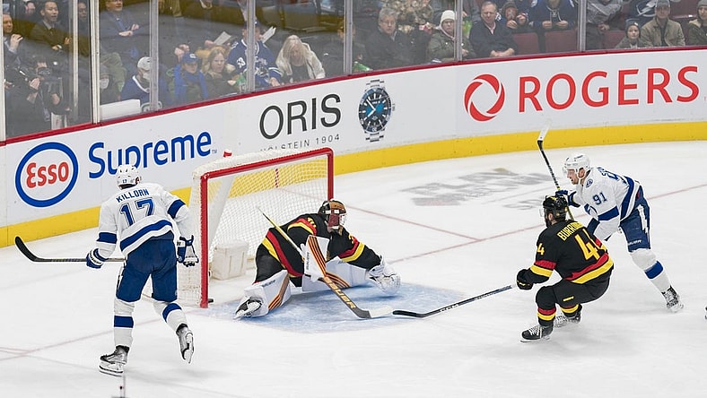 Jan 18, 2023; Vancouver, British Columbia, CAN; Tampa Bay Lightning forward Alex Killorn (17) watches as forward Steven Stamkos (91) scores his 500th career NHL goal on Vancouver Canucks goalie Spencer Martin (30) while defenseman Kyle Burroughs (44) looks on in the first period at Rogers Arena. Mandatory Credit: Bob Frid-USA TODAY Sports