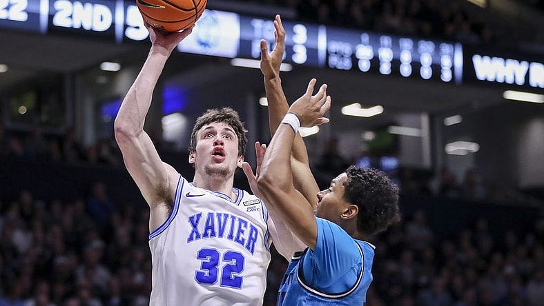 Jan 21, 2023; Cincinnati, Ohio, USA; Xavier Musketeers forward Zach Freemantle (32) shoots against Georgetown Hoyas guard Wayne Bristol Jr. (31) in the second half at Cintas Center. Mandatory Credit: Katie Stratman-USA TODAY Sports