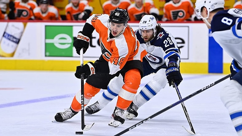 Jan 22, 2023; Philadelphia, Pennsylvania, USA; Philadelphia Flyers center Morgan Frost (48) reaches for the puck against Winnipeg Jets center Kevin Stenlund (28) in the second period at Wells Fargo Center. Mandatory Credit: Kyle Ross-USA TODAY Sports