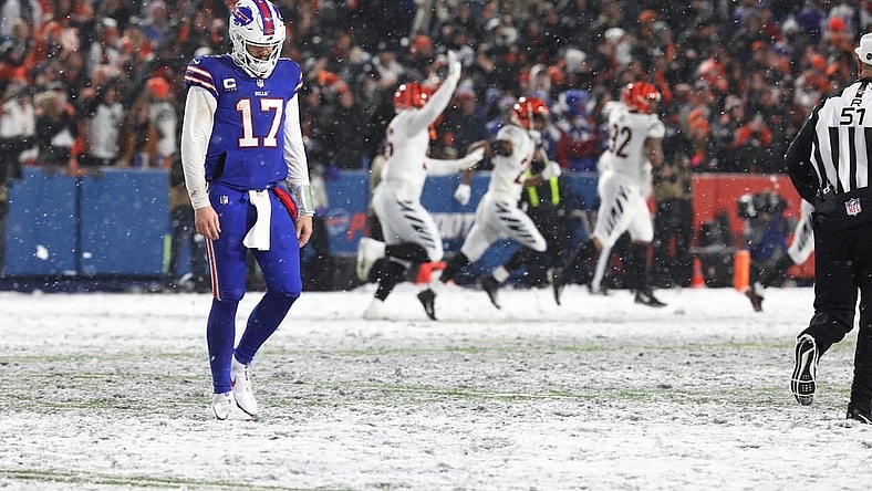 Bills quarterback Josh Allen walks off the field after throwing an interception late in the fourth quarter at Highmark Stadium in Orchard Park on Jan. 22 In the background the Cincinnati Bengals players celebrate.
Ty 012223 Dejected Josh Allen After Fourth Quarter Interception