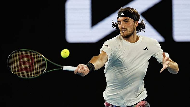 Jan 24, 2023; Melbourne, Victoria, Australia;  Stefanos Tsitsipas of Greece hits a shot against Jiri Lehecka of the Czech Republic on day nine of the 2023 Australian Open tennis tournament at Melbourne Park. Mandatory Credit: Mike Frey-USA TODAY Sports