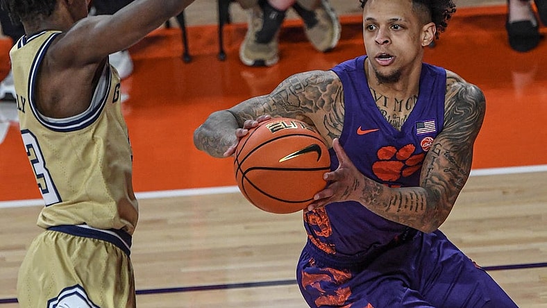 Jan 24, 2023; Clemson, South Carolina, USA; Clemson Tigers guard Brevin Galloway (11) moves the ball against Georgia Tech Yellow Jackets forward Jordan Meka (23) during the first half at Littlejohn Coliseum. Mandatory Credit: Ken Ruinard-USA TODAY Sports