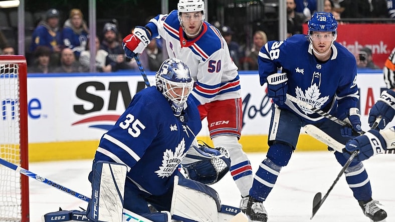 Jan 25, 2023; Toronto, Ontario, CAN;  Toronto Maple Leafs goalie Ilya Samsonov (35) makes a save as defenseman Rasmus Sandin (38) and New York Rangers forward Will Cuyle (50) look for the rebound in the second period at Scotiabank Arena. Mandatory Credit: Dan Hamilton-USA TODAY Sports