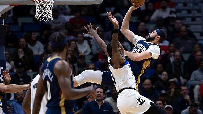 Jan 25, 2023; New Orleans, Louisiana, USA;  New Orleans Pelicans forward Larry Nance Jr. (22) shoots a jump shot against Minnesota Timberwolves forward Jaden McDaniels (3) during the first half at Smoothie King Center. Mandatory Credit: Stephen Lew-USA TODAY Sports