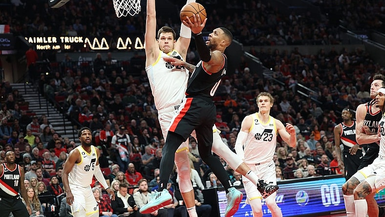 Jan 25, 2023; Portland, Oregon, USA;  Portland Trail Blazers guard Damian Lillard (0) shoots over Utah Jazz forward Jarred Vanderbilt (8) in the second half at Moda Center. Mandatory Credit: Jaime Valdez-USA TODAY Sports