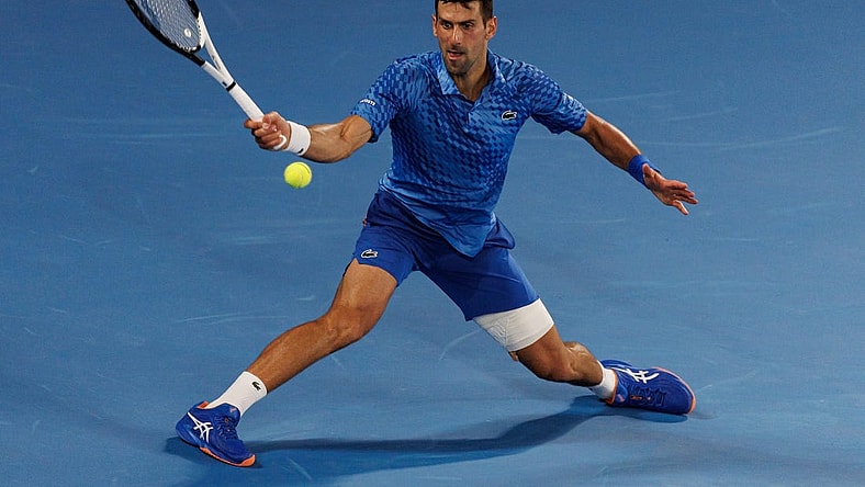 Jan 27, 2023; Melbourne, Victoria, Australia;  Novak Djokovic of Serbia hits a shot against Tommy Paul of the United States on day twelve of the 2023 Australian Open tennis tournament at Melbourne Park. Mandatory Credit: Mike Frey-USA TODAY Sports