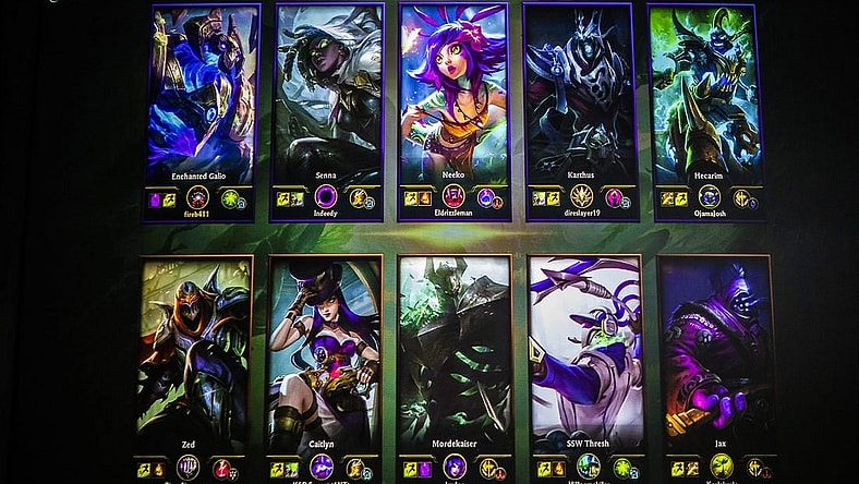 The loading screen for League of Legends is seen projected on the wall behind the competitors. The loading screen comes up while waiting for the game to start, allowing players to view each characters basic information before the battle. Jan. 24, 2020