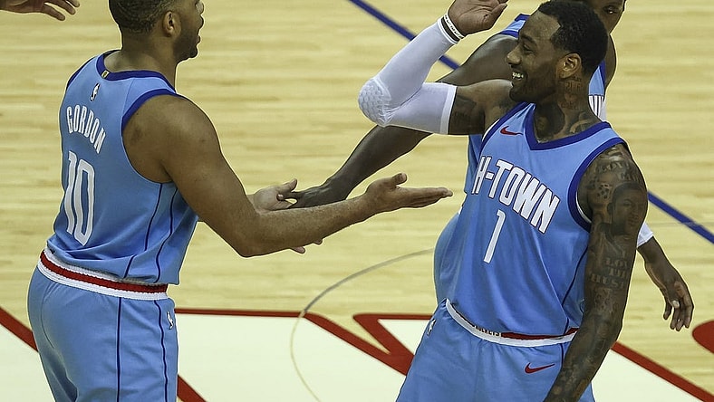 Jan 28, 2021; Houston, Texas, USA; Houston Rockets guard Eric Gordon (10) and guard John Wall (1) celebrate after a play during the fourth quarter against the Portland Trail Blazers at Toyota Center. Mandatory Credit: Troy Taormina-USA TODAY Sports