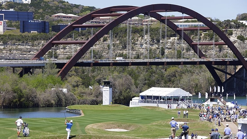 Mar 25, 2021; Austin, Texas, USA; Bryson DeChambeau hits his approach on #12 during the second day of the WGC Dell Technologies Match Play golf tournament at Austin Country Club. The Pennybacker Bridge, one of the signature landmarks of Austin, spans Lake Austin in the background. Mandatory Credit: Erich Schlegel-USA TODAY Sports