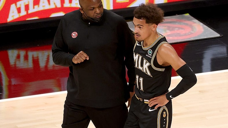 May 5, 2021; Atlanta, Georgia, USA; Atlanta Hawks coach Nate McMillan talks with guard Trae Young (11) during a time out of their game against the Phoenix Suns at State Farm Arena. Mandatory Credit: Jason Getz-USA TODAY Sports