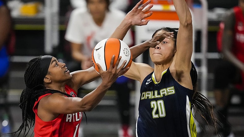 May 27, 2021; College Park, Georgia, USA; Atlanta Dream center/forward Elizabeth Williams (1) drives to the basket against Dallas Wings forward Isabelle Harrison (20) during the second half at Gateway Center Arena at College Park. Mandatory Credit: Dale Zanine-USA TODAY Sports