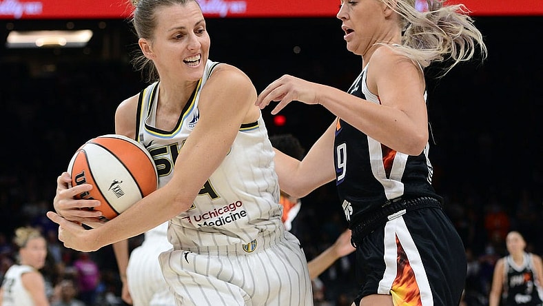 Oct 13, 2021; Phoenix, Arizona, USA; Chicago Sky guard Allie Quigley (14) protects the ball from Phoenix Mercury guard Sophie Cunningham (9) during the first half of game two of the 2021 WNBA Finals at Footprint Center. Mandatory Credit: Joe Camporeale-USA TODAY Sports