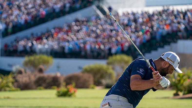 Feb 11, 2022; Scottsdale, Arizona, USA; Jon Rahm plays his tee shot on the par 3 16th hole during the second round of the WM Phoenix Open golf tournament. Mandatory Credit: Allan Henry-USA TODAY Sports