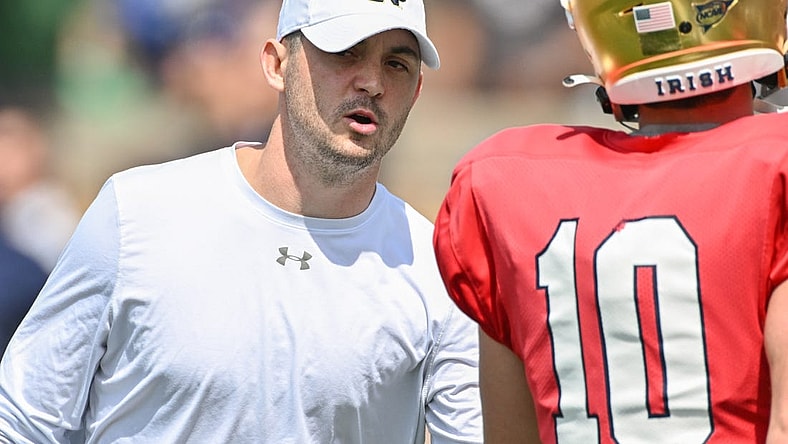 Apr 23, 2022; Notre Dame, Indiana, USA; Notre Dame Fighting Irish offensive coordinator Tommy Rees talks to quarterback Drew Pyne (10) during warmups before the Blue-Gold Game at Notre Dame Stadium. Mandatory Credit: Matt Cashore-USA TODAY Sports