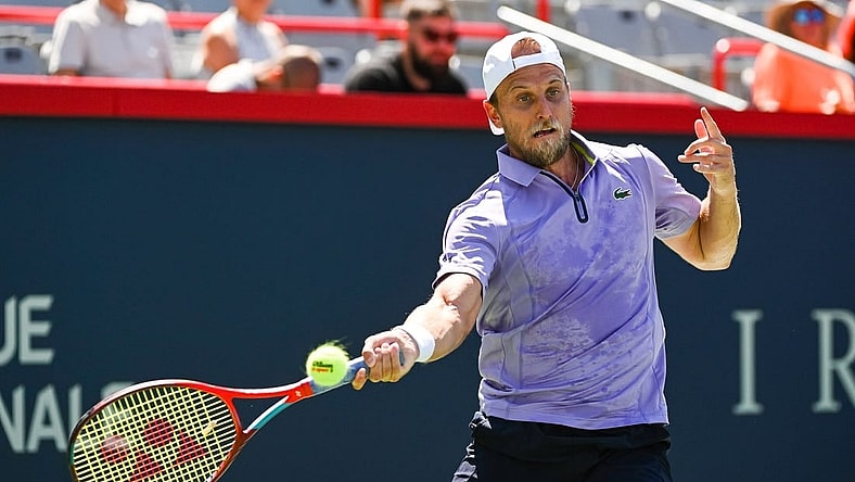 Aug 6, 2022; Montreal, Quebec, Canada; Denis Kudla (USA) hits a shot against Benoit Paire (FRA) (not pictured) in first round qualifying play at IGA Stadium. Mandatory Credit: David Kirouac-USA TODAY Sports