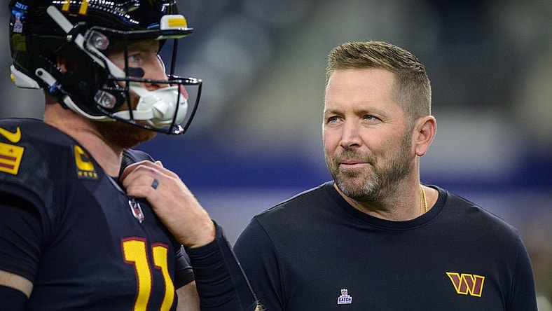 Oct 2, 2022; Arlington, Texas, USA; Washington Commanders quarterback Carson Wentz (left) talks with offensive coordinator Scott Turner (right) before the game between the Dallas Cowboys and the Washington Commanders at AT&T Stadium. Mandatory Credit: Jerome Miron-USA TODAY Sports