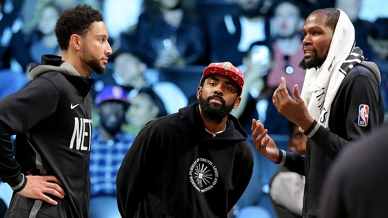 Oct 6, 2022; Brooklyn, New York, USA; Brooklyn Nets guard Kyrie Irving (center) talks to guard Ben Simmons (left) and forward Kevin Durant (7) during the fourth quarter against the Miami Heat at Barclays Center. Mandatory Credit: Brad Penner-USA TODAY Sports